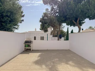 a white fence in front of a white building at Casa Vaga - Garrão beach House