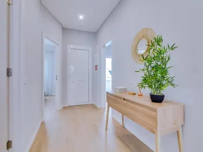 a room with a table with a potted plant on it at Casa da Avó Marquinhas in Quarteira