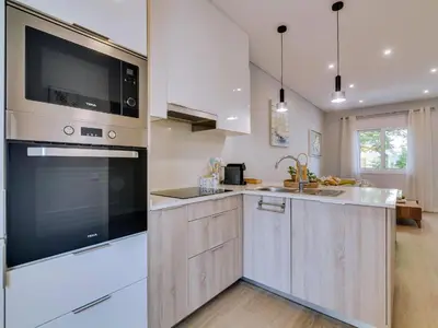 a kitchen with a large oven and a sink at Casa da Avó Marquinhas in Quarteira