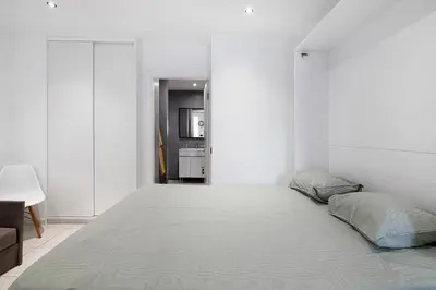 a bedroom with a large bed in a white room at Mi Casa Es Su Casa Nº1 in Albufeira