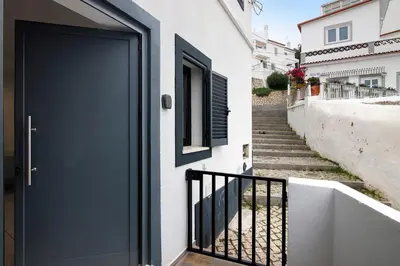 a blue door on a white house with stairs at Mi Casa Es Su Casa Nº1 in Albufeira