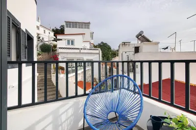 a blue chair sitting on top of a balcony at Mi Casa Es Su Casa Nº3 in Albufeira