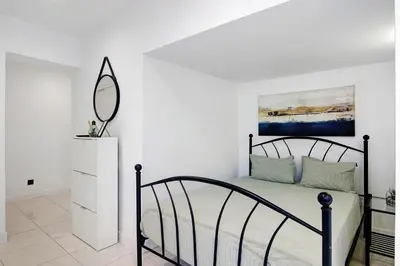 a bedroom with a bed with a mirror on the wall at Mi Casa Es Su Casa Nº2 in Albufeira