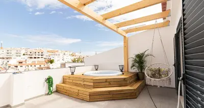 a dining room and living room with a glass table and chairs at Mi Casa Es Su Casa Nº5 in Albufeira