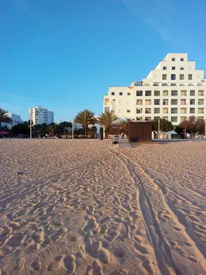 a group of people playing on a playground at the beach at Cartaia Apartamento Leste in Quarteira