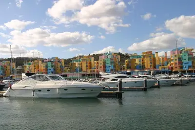 a group of boats docked in a harbor with buildings at APT T2 - Marina de Albufeira in Albufeira