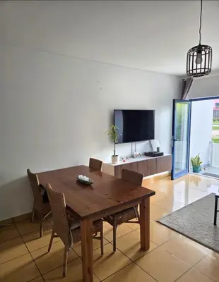 a dining room with a wooden table and chairs at APT T2 - Marina de Albufeira in Albufeira