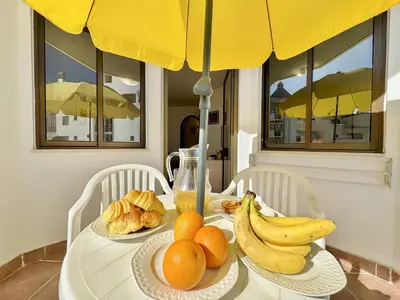 a table with bananas oranges and other food on it at Vilamoura Central 12 With Pool by Homing in Vilamoura