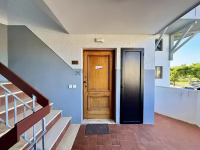 a wooden door in a house with stairs at Vilamoura Central 12 With Pool by Homing in Vilamoura
