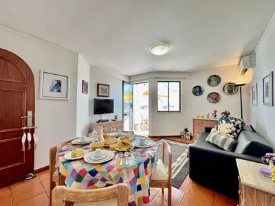 a living room with a table and a couch at Vilamoura Central 12 With Pool by Homing in Vilamoura
