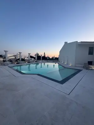 a swimming pool on the roof of a building at HC2 Village Vilamoura in Quarteira