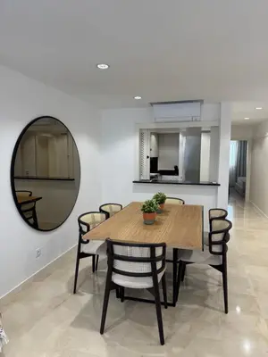 a dining room with a table and chairs and a mirror at HC2 Village Vilamoura in Quarteira