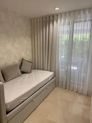 a bed in a room with a large window at HC2 Village Vilamoura in Quarteira