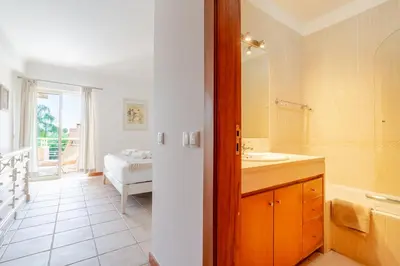 a bathroom with a sink and a refrigerator at Coastal Pines by Seareen in Quarteira