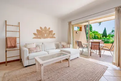 a living room with a white couch and a table at Coastal Pines by Seareen in Quarteira