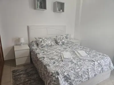 a bed with two books on it in a bedroom at Townhouse Sol&Mar Vilamoura in Vilamoura
