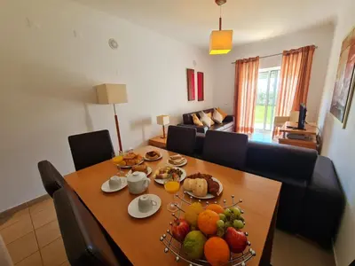 a dining room table with a bunch of fruit on it at Encosta Sao Jose - Apartment BF in Albufeira
