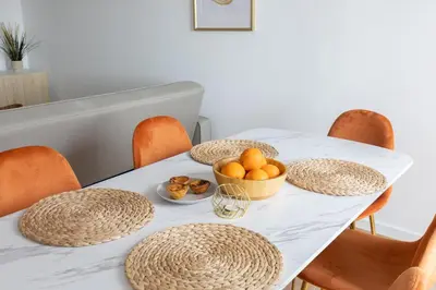 a table with chairs and a bowl of oranges on it at Golden Nest - Faro Old Town in Faro