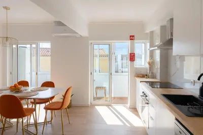 a kitchen with a table and chairs and a dining room at Golden Nest - Faro Old Town in Faro