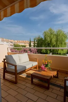 a couch and a coffee table on a balcony at Apartamento T2 duplex - Vilamoura in Quarteira