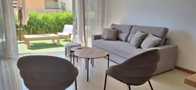 a living room with a couch and a wooden table at Sossego a Sul in Albufeira