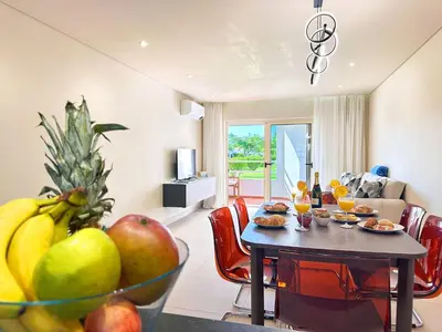 a living room with a table with fruit on it at Oura Modern Poolside Condo by BeCherish in Vale de Pedras