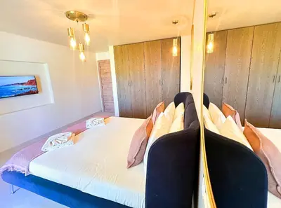 a bedroom with a large bed with pillows at Oura Modern Poolside Condo by BeCherish in Vale de Pedras