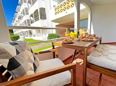 a table with fruit on it on a patio at Oura Modern Poolside Condo by BeCherish in Vale de Pedras