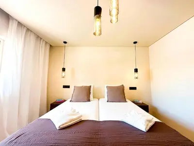 a bedroom with a large bed with two pillows at Oura Modern Poolside Condo by BeCherish in Vale de Pedras