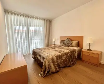a bedroom with a bed and a large window at The Navigator Olympus in Quarteira