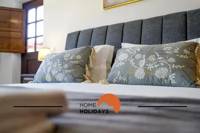 a bedroom with a bed with a headboard and pillows at #240 Beach House - Casa da Balaia by Home Holidays in Olhos de Água