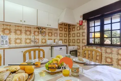 a kitchen with a table with food on it at #240 Beach House - Casa da Balaia by Home Holidays in Olhos de Água