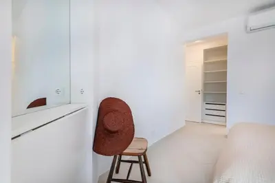 a white living room with a couch and a fireplace at Clube Albufeira - 2BR Pool, Kids Club & Family Fun in Albufeira