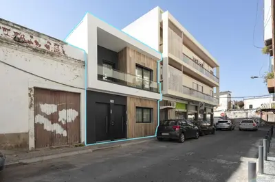 a street with cars parked in front of buildings at Castilhos 1 - City center by HD in Faro