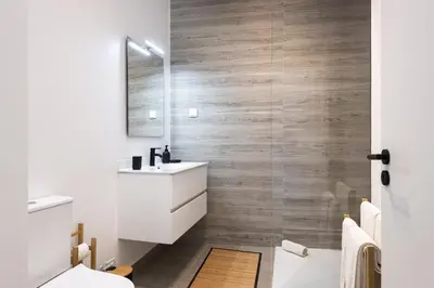 a bathroom with a white sink and a mirror at Castilhos 1 - City center by HD in Faro