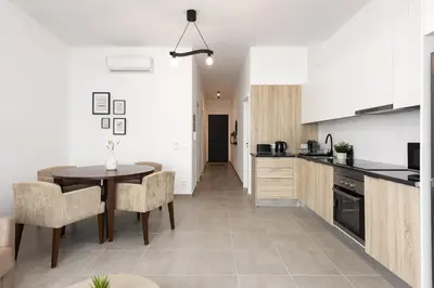 a kitchen and dining room with a table and chairs at Castilhos 1 - City center by HD in Faro