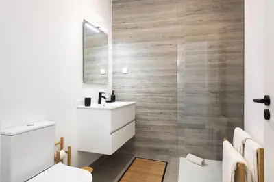 a bathroom with a white sink and a mirror at Castilhos 2 - City center by HD in Faro