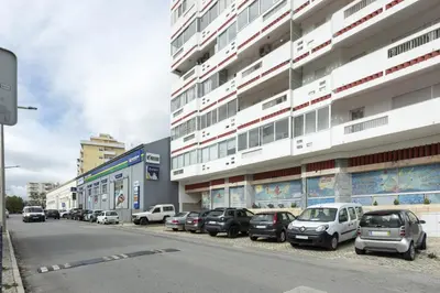 a row of cars parked in front of a building at Salty - Near the city by HD in Faro