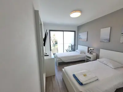 a bedroom with two beds and a window at Luxury Design Villa (Private Pool & Jacuzzi) in Albufeira