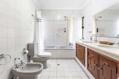 a bathroom with a toilet and a sink and a tub at 2 BDR Flat With Pool in Vilamoura by LovelyStay in Quarteira