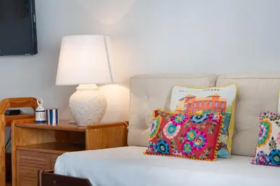 a bedroom with a bed with a lamp and pillows at 2 BDR Flat With Pool in Vilamoura by LovelyStay in Quarteira