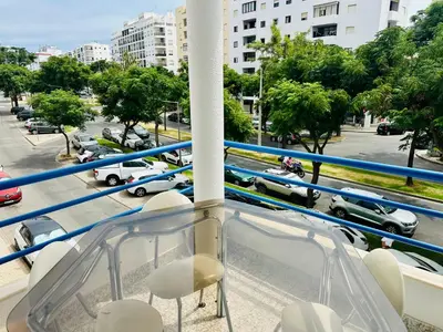 a balcony with chairs and a view of a parking lot at Milennium Holiday Apartment in Quarteira