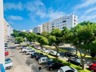 a parking lot full of cars in a city at Milennium Holiday Apartment in Quarteira