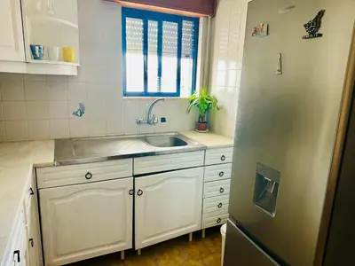 a kitchen with a sink and a refrigerator at Milennium Holiday Apartment in Quarteira