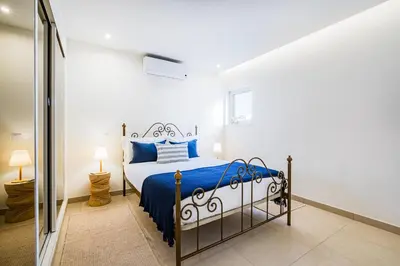 a bedroom with a bed with blue and white sheets at Apartamento oceano in Albufeira