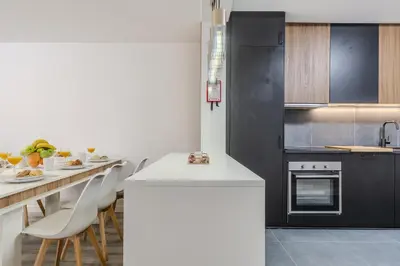 a living room with a tv and a table at #022 T2 Velamar by Home Holidays in Albufeira