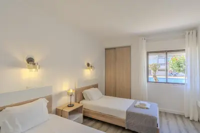 a living room with a couch and a tv at #022 T2 Velamar by Home Holidays in Albufeira