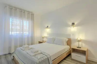 a bedroom with a bed with a home holidays sign on it at #022 T2 Velamar by Home Holidays in Albufeira