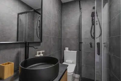a bathroom with a shower and a black sink at #022 T2 Velamar by Home Holidays in Albufeira