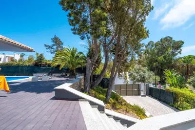 a patio with trees and a swimming pool at Balaia Retreat - Nature & Beach in Olhos de Água